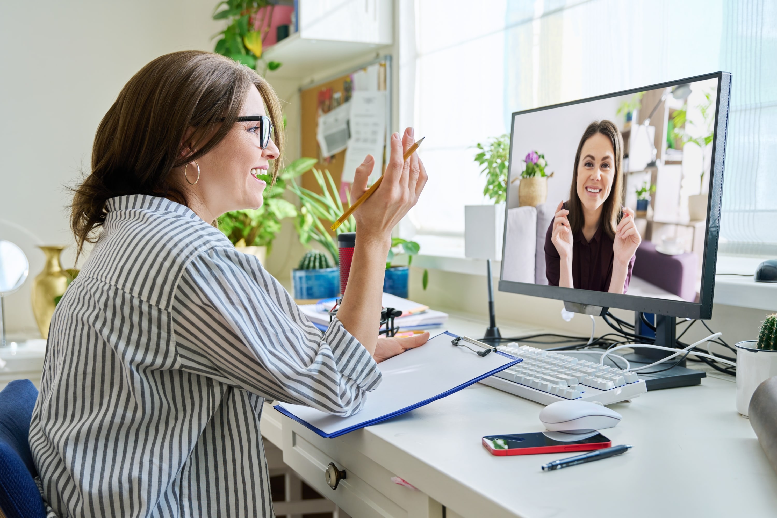 woman talking online with young female using video call