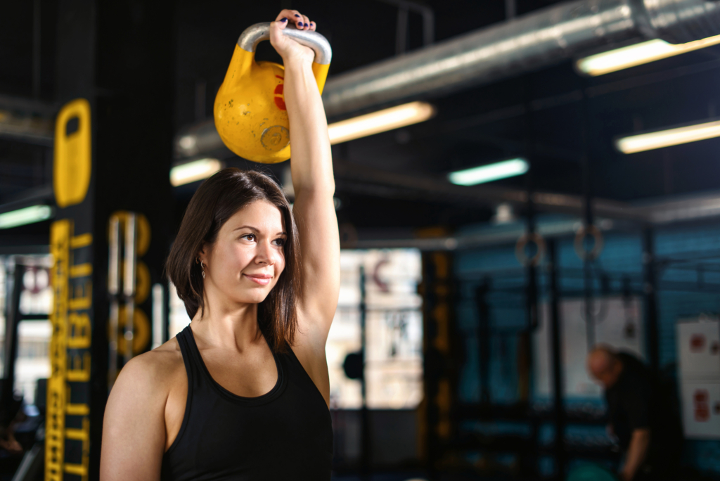 woman doing a kettlebell press