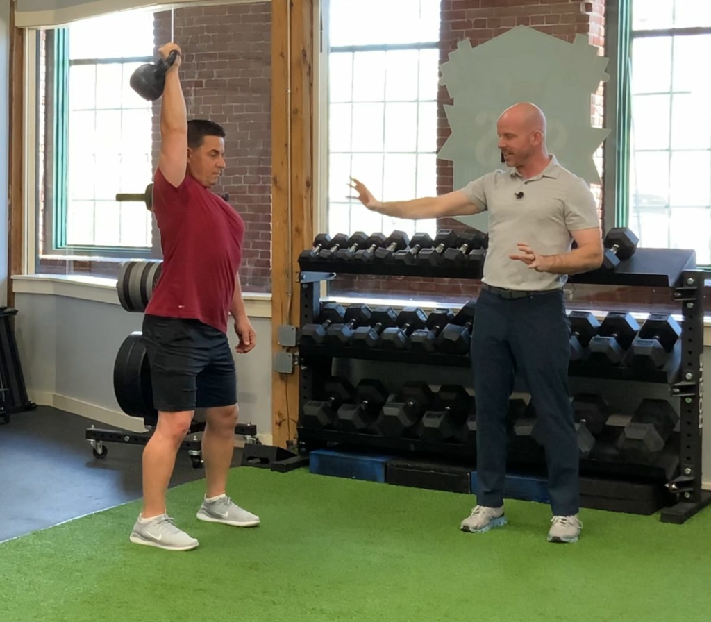 AFPA Principles of Exercise Programming Instructors Demonstrating a Kettlebell Overhead Press